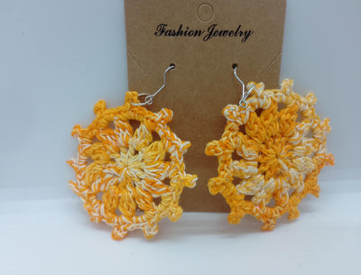 Displayed against a brown card labeled as Fashion Jewelry, the Handmade Crochet Earrings from FashionableCrochet showcase a gradient of yellow and orange hues. These intricately designed earrings feature floral patterns and hypoallergenic hooks for added comfort and style.