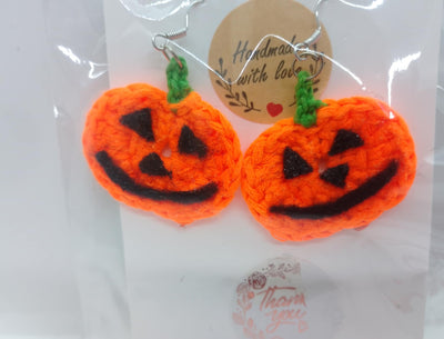 Displayed on a card labeled Handmade with love, the FashionableCrochet’s Handmade Crochet Halloween Earrings feature two cheerful pumpkins with black smiling faces and green stems—an ideal custom accessory for Halloween.